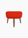 Front view of the Oda Ottoman upholstered in a vibrant red Hallingdal 600 fabric, with three tapered legs in a walnut finish.