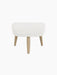 An Oda Ottoman with a light grey textured fabric seat and four tapered legs in natural oak, viewed from the front.