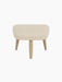 Front view of the Oda Ottoman, upholstered in a light cream Hallingdal 200 fabric, with four angled legs in natural oak.