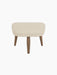 Front view of the Oda Ottoman, with a rectangular cushioned seat in light Hallingdal fabric and four tapered walnut legs.