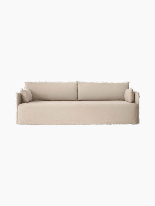 Front view of the Offset 3-Seater Sofa with Loose Cover in sand, with two large back and two smaller side cushions.