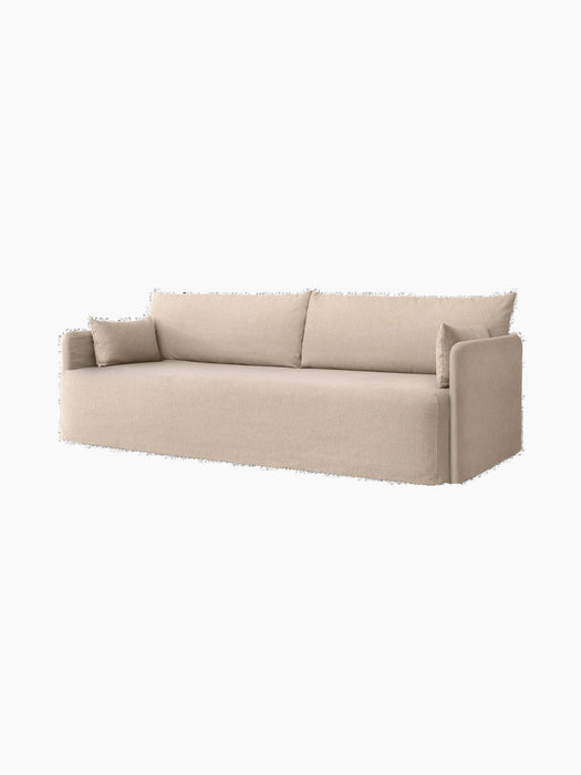 Angled view of the Audo Offset Sofa with Loose Cover. The 3-seater sofa is upholstered in a textured sand-coloured fabric.