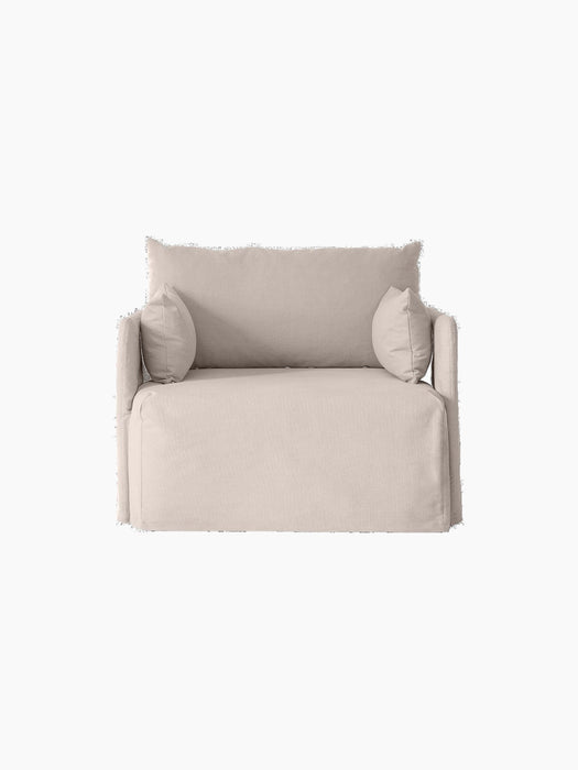 Front view of the Offset Sofa with Loose Cover, a 1-seater armchair in a light grey fabric, isolated on a black background.