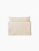 Back view of the Offset Sofa with a loose cover. The 1-seater armchair is upholstered in a textured, light cream fabric.