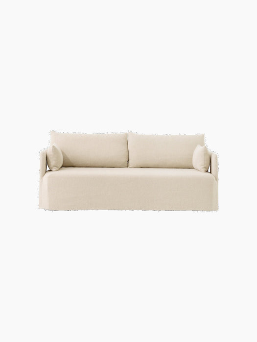 A frontal view of the Offset 2-seater Sofa with a loose cover in a light, textured Logan Jasmine fabric.