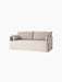 Angled view of the Offset Sofa w. Loose Cover in a light grey fabric, with two large back and two smaller side cushions.