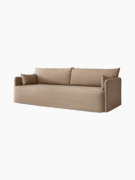 Angled view of the 3-seater Offset Sofa with a loose cover in a textured, light brown Flint fabric against a plain backdrop.