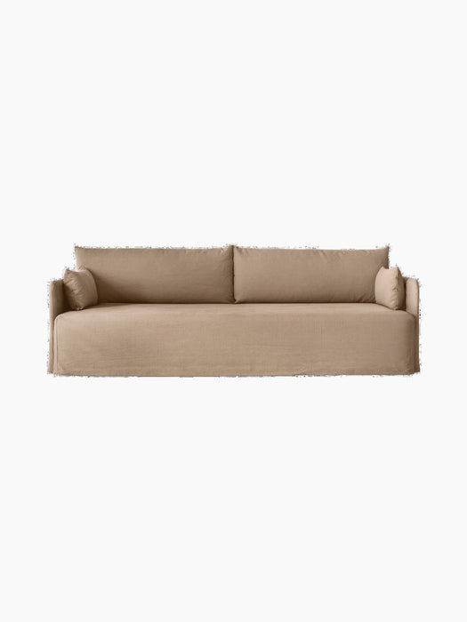 Front view of the 3-seater Offset Sofa. It has a silhouette with a loose cover in textured Flint fabric and soft cushions.
