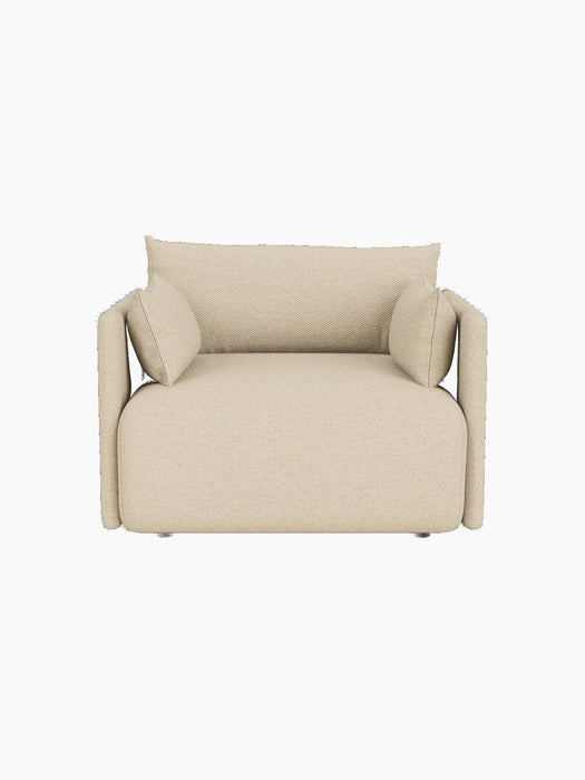 A front, high-angle view of the Offset Sofa, a one-seater armchair upholstered in textured, sand-coloured Logan fabric.