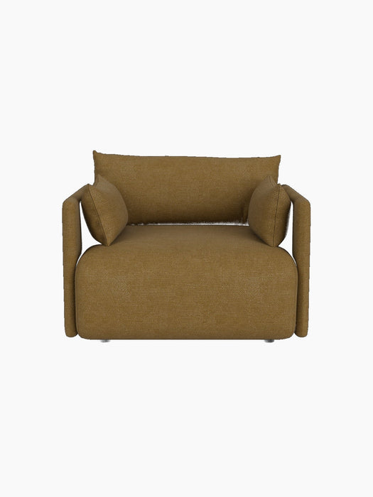 Front view of the Offset Sofa, a one-seater armchair upholstered in mustard Audo Bouclé 06 fabric, on a black background.