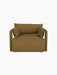 Front view of the Offset Sofa, a one-seater armchair upholstered in mustard Audo Bouclé 06 fabric, on a black background.