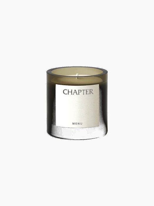 The Olfacte Scented Candle, Chapter Votive Candle in a dark glass jar. A white label on the front reads 'CHAPTER' and 'MENU'.