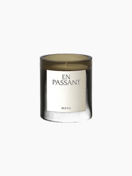 The Olfacte Scented Candle, En Passant, in a dark glass jar. A white label on the front reads 'EN PASSANT' and 'MENU'.