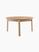 A front-facing image of the round Passage Lounge Table in natural oak, showcasing its circular top and four solid wood legs.