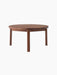 A solid walnut Passage Lounge Table with a round top and four straight legs, against a plain black background.
