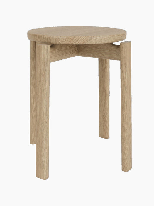 A Passage Stool with a round seat in natural oak, shown from a three-quarters angle against a black background.