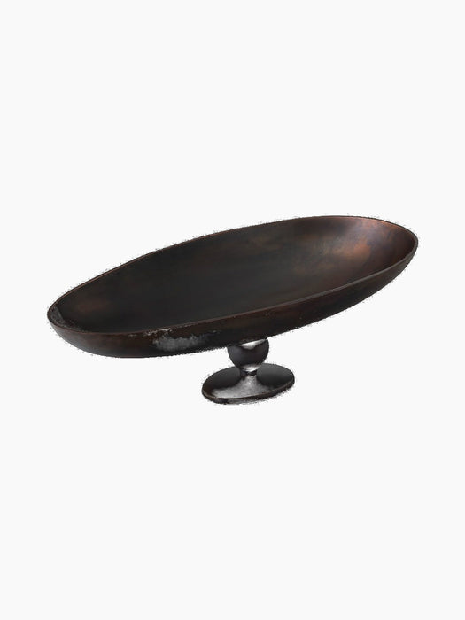 Angled view of a wide, oval decorative bowl on a pedestal. The bowl features a dark, patinated bronze finish.