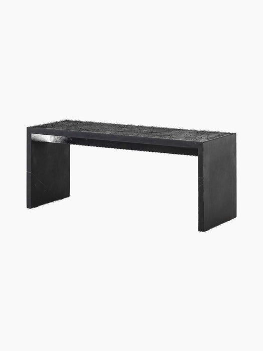 The Plinth Bridge in Nero Marquina, a long and low rectangular bench of black marble with white veins, viewed at an angle.