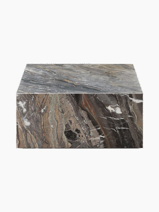A side view of Plinth Low table in Grey Galaxy Marble, a rectangular podium with dramatic swirls of grey, brown, and white.