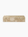 A front view of the Plinth Low, a rectangular podium crafted from textural Kunis Breccia stone with beige and cream tones.