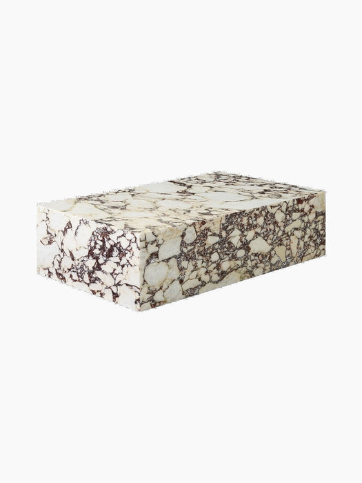 A low-angle view of the rectangular Plinth Low table in Calacatta Viola marble, featuring a white base with purple veining.