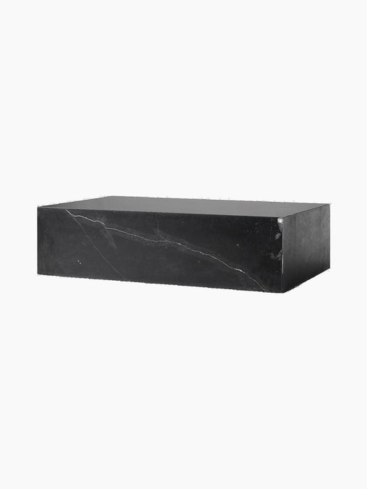 A packshot of the Plinth Low in black Nero Marquina marble with white veins, shown at an angle against a black background.