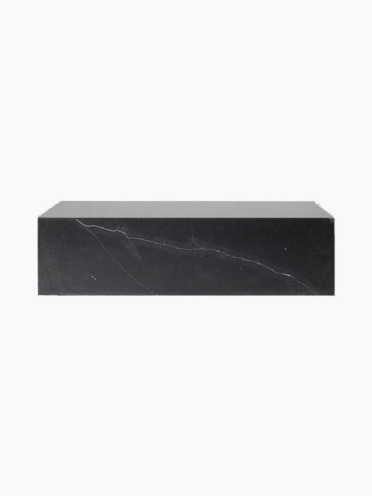 Front view of the Plinth Low, a long rectangular podium made of black Nero Marquina marble with distinctive white veining.