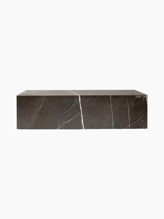 A rectangular Plinth Low table made from brown-grey marble with striking white veins, isolated on a black background.