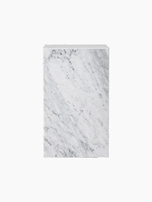 A front-facing image of the Plinth Tall. The rectangular pedestal is made of white Carrara marble with subtle grey veins.