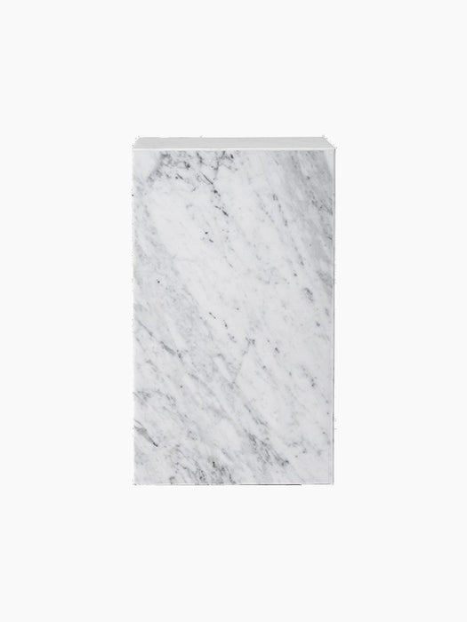 The Plinth Tall, a rectangular pedestal crafted from white marble with grey veining, displayed against a black background.