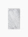 The Plinth Tall, a rectangular pedestal crafted from white marble with grey veining, displayed against a black background.