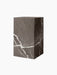 The Plinth Tall in Brown-Grey Marble, a rectangular pedestal at an angle, featuring bold white veining on a dark surface.