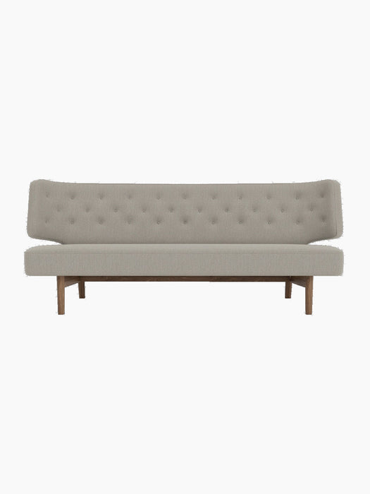 A front view of the Radiohus Sofa P2, featuring light grey Re-Wool 218 upholstery with button-tufting and a walnut frame.