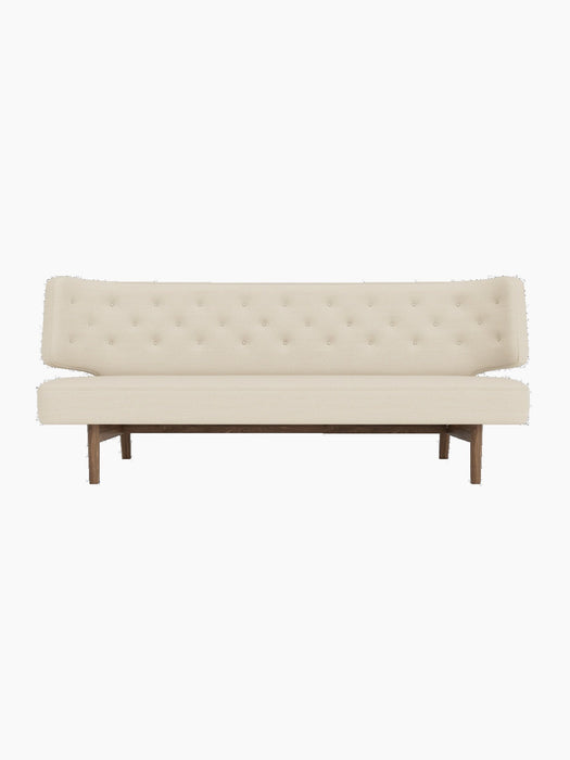 Front view of the Radiohus Sofa P2 in light cream upholstery with a button-tufted back and a dark walnut wood frame.