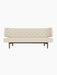 Front view of the Radiohus Sofa P2 in light fabric upholstery, with a quilted back with brown buttons and a walnut frame.