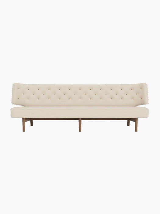Front view of the Radiohus Sofa P3 with a walnut frame, cream upholstery and a tufted backrest with brown leather buttons.
