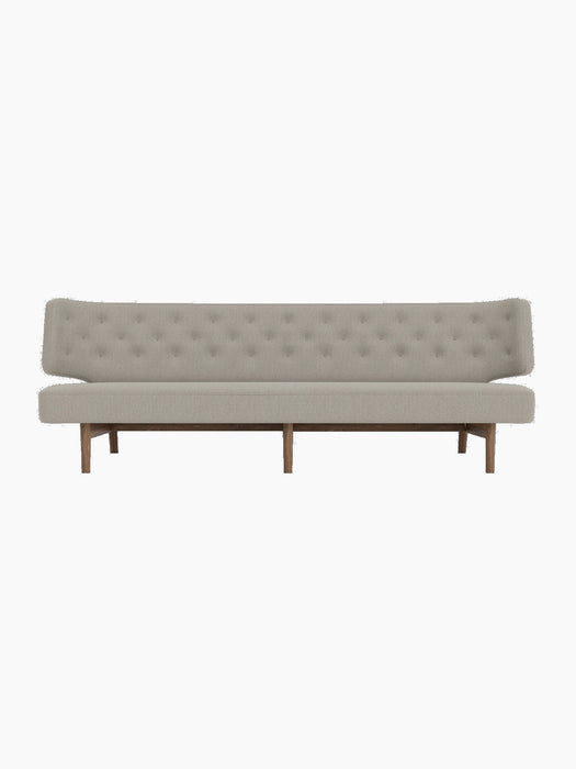 Front view of the Radiohus Sofa P3, featuring a long, button-tufted backrest, light grey upholstery, and a dark walnut frame.