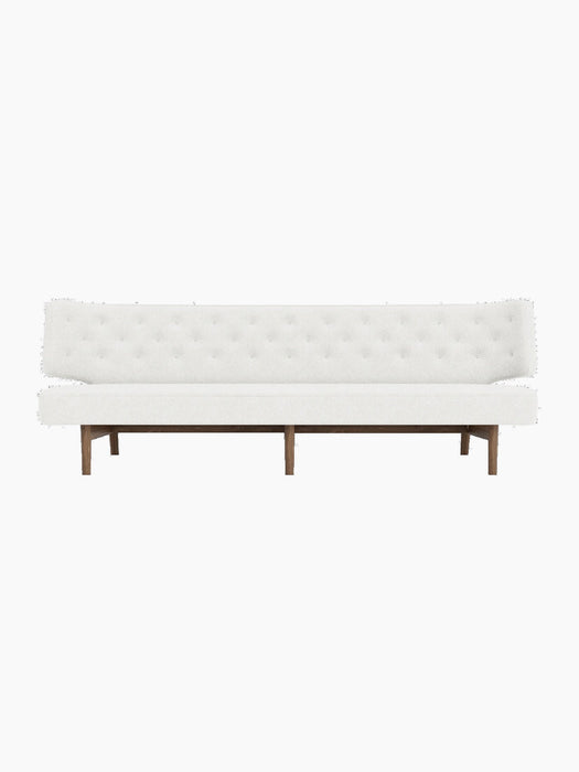 Front view of the Radiohus Sofa P3 with white, button-tufted upholstery and a dark walnut frame on a black background.