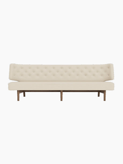 Front view of the Radiohus Sofa P3 in a cream button-tufted upholstery, with a dark walnut frame, on a black background.