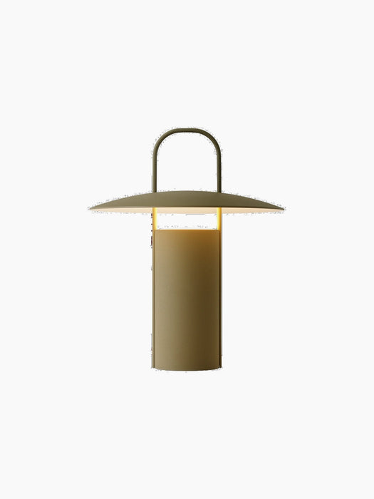 A front view of the illuminated Ray Table Lamp, Portable, in a matte dusty green finish, set against a black background.