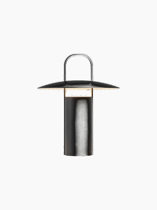 A front-on view of the black Ray Table Lamp, Portable. The lamp has a cylindrical base, a wide, disc-like shade, and a handle