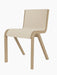 A three-quarter view of the Ready Dining Chair, Front Upholstered, with a natural oak frame and light, textured upholstery.