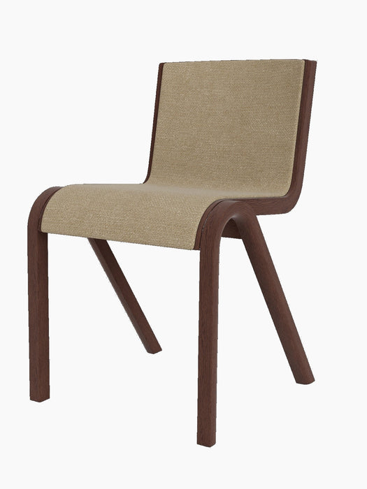 A three-quarter view of the Ready Dining Chair, with a red-stained oak frame and front upholstery in light brown bouclé.