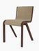 A three-quarter view of the Ready Dining Chair, with a red-stained oak frame and front upholstery in light brown bouclé.