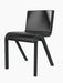 Angled view of the Ready Dining Chair. It has a black oak frame with visible grain and a seat upholstered in black leather.