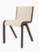 A three-quarter view of the Ready Dining Chair, featuring a red stained oak frame and a seat upholstered in Logan Jasmine.
