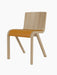 Front three-quarter view of the Ready Dining Chair. It has a natural oak frame and a tan upholstered seat.