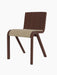 A side view of the Ready Dining Chair with a red-stained oak frame and a seat upholstered in light Audo Bouclé fabric.