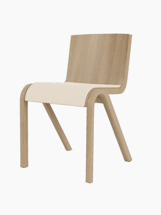 A three-quarter view of the Ready Dining Chair with a natural oak frame and its seat upholstered in Logan Jasmin fabric.