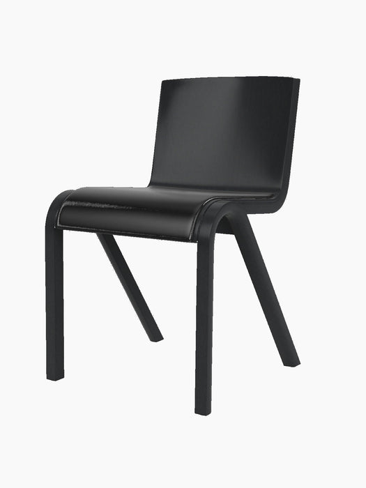 A three-quarter view of the Ready Dining Chair. It has a black painted oak frame and a seat upholstered in dark material.
